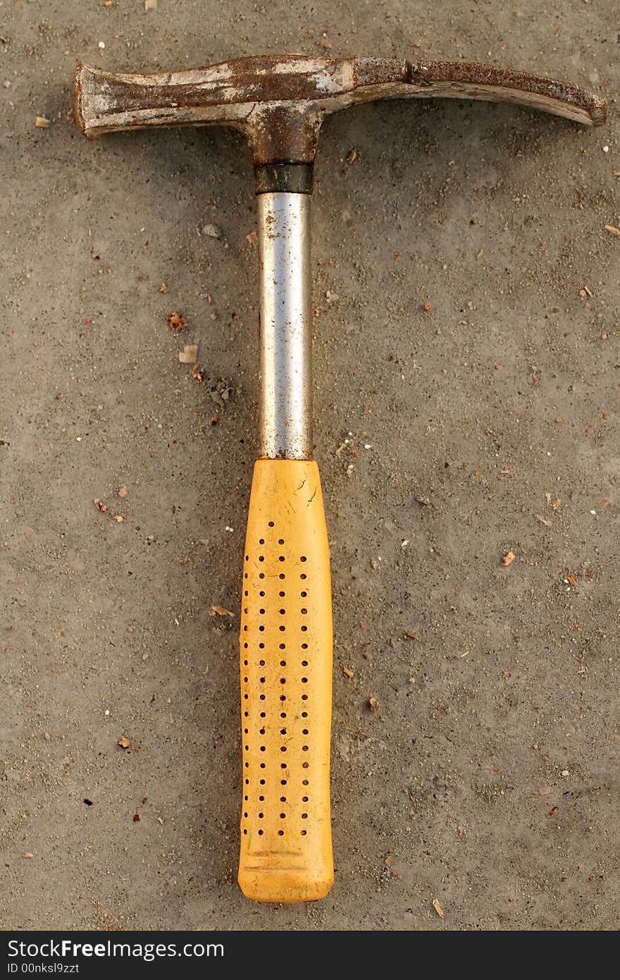 Close - up of metal hammer isolated on concrete background.