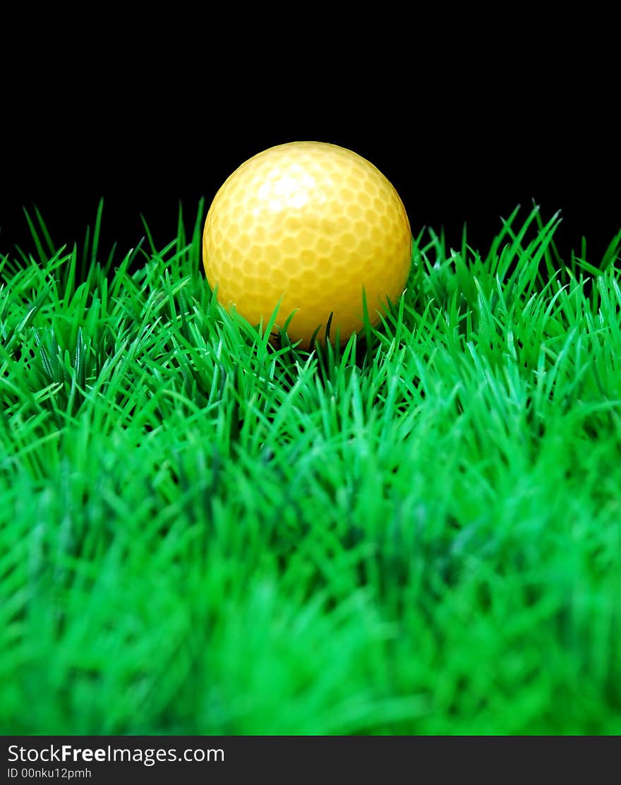 Golfball in  green fairway, isolated on black background