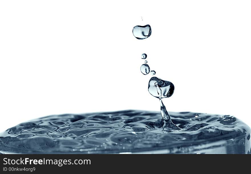 Isolated blue drops are falling down and impact with liquid surface. Isolated blue drops are falling down and impact with liquid surface