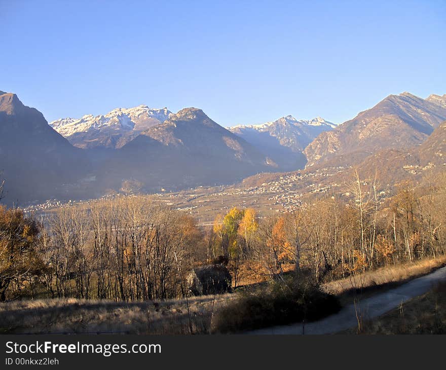 A panorama of Ossola Valley. Mountains in fall season with the first snow, Italy, HDR. A panorama of Ossola Valley. Mountains in fall season with the first snow, Italy, HDR