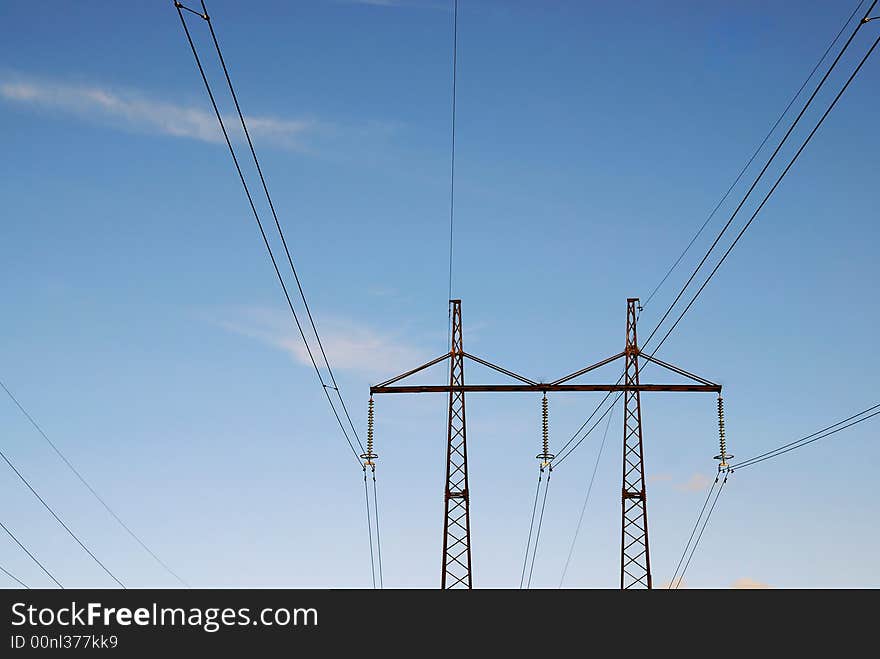 Electric line with isolators on blue sky background