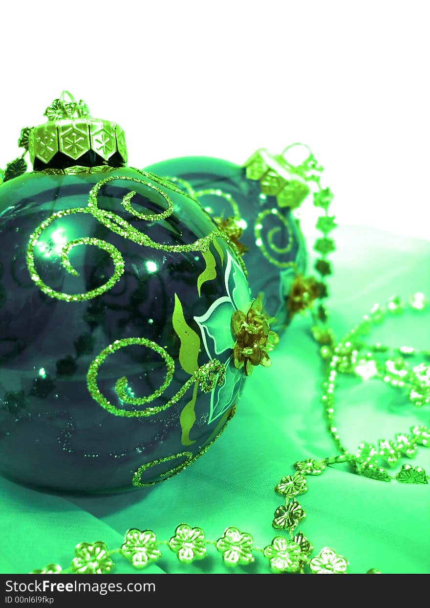 Green Christmas balls with gold on background