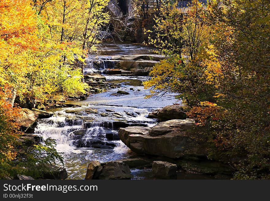 Colorful scene of creek and autumn trees along the bank. Colorful scene of creek and autumn trees along the bank