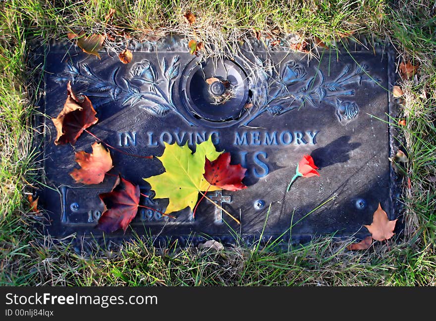 Autumn leaves adorn a final place of rest. Autumn leaves adorn a final place of rest.