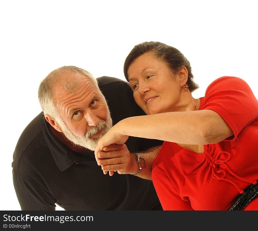 Attractive older couple in love with the gentleman kissing his lovely dame's hand; isolated on white. Attractive older couple in love with the gentleman kissing his lovely dame's hand; isolated on white