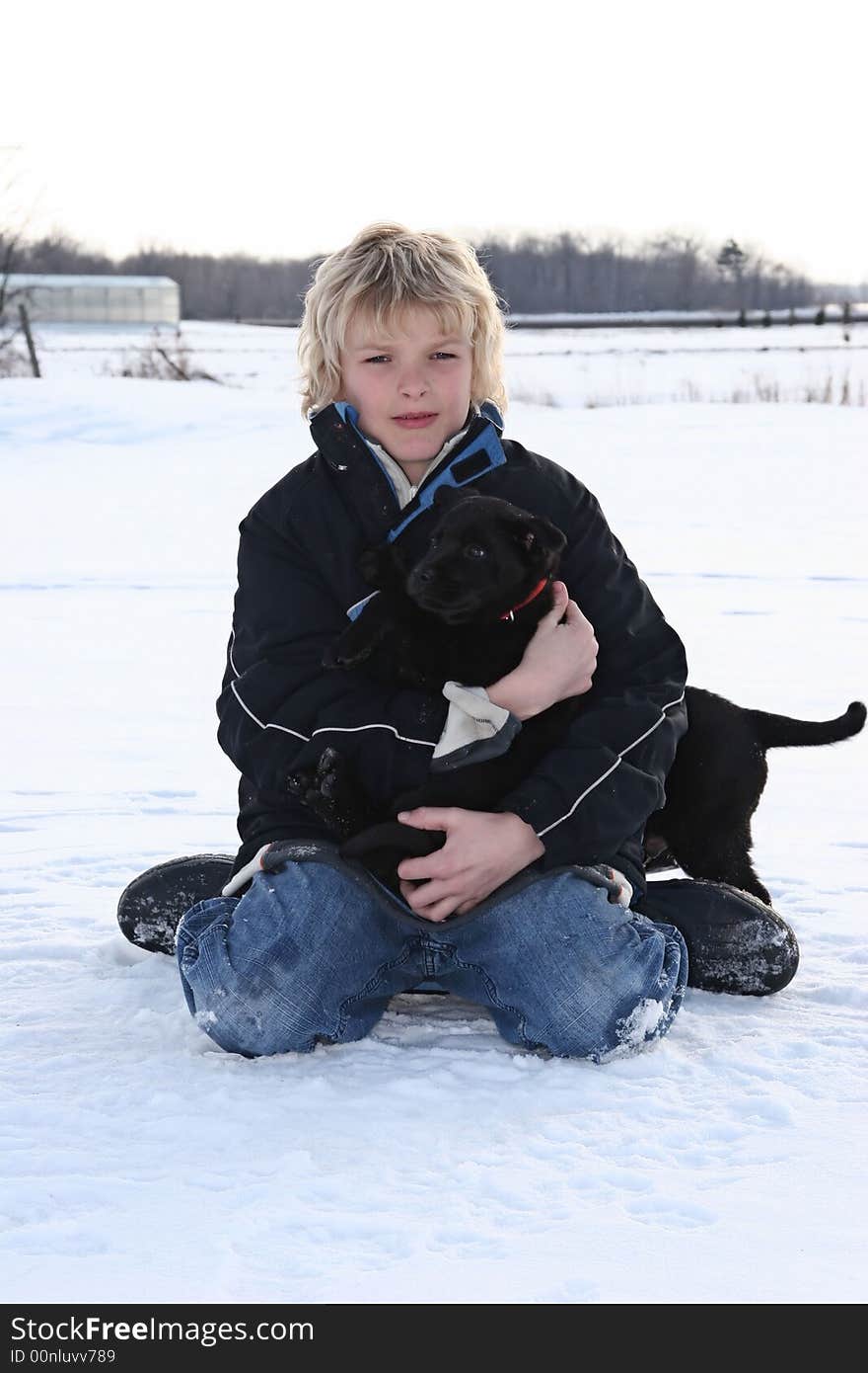 Young boy in the snow with his puppy. Young boy in the snow with his puppy