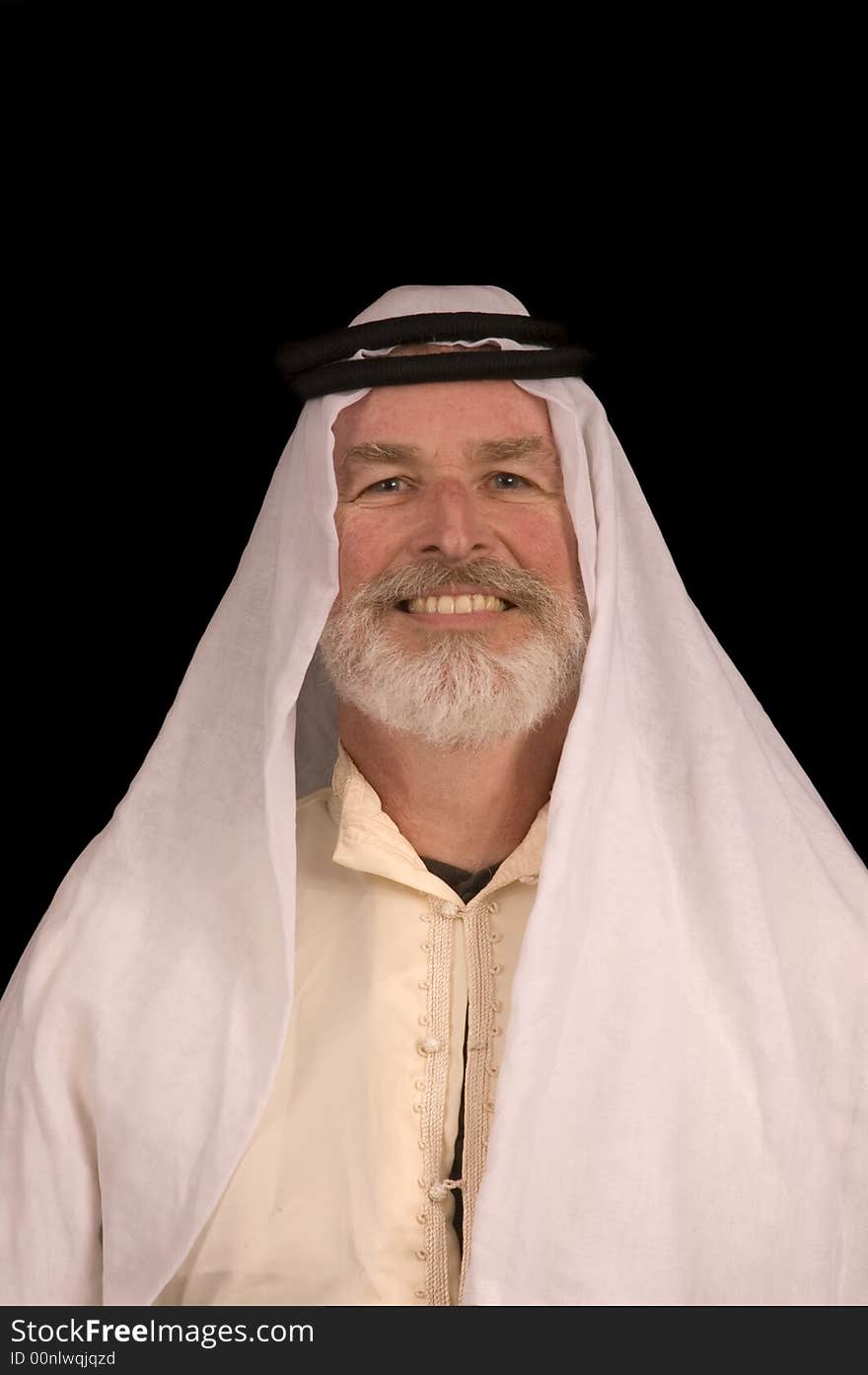 Older middle-eastern man with white beard, in Arabian headress and sunglasses isolated on black. Older middle-eastern man with white beard, in Arabian headress and sunglasses isolated on black