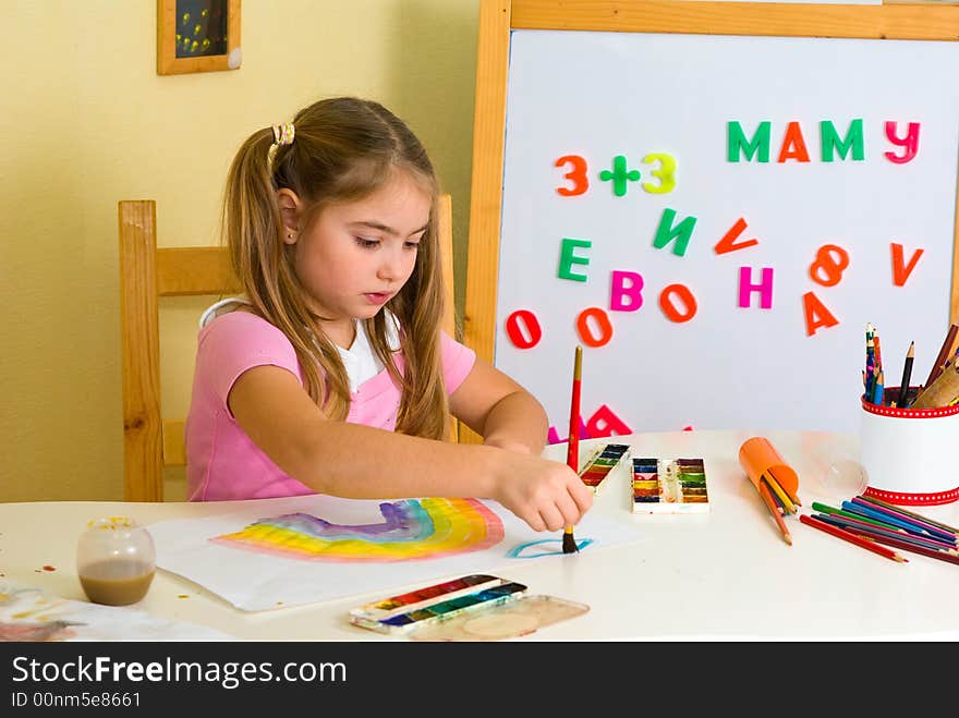 Pretty schoolgirl has drawn a rainbow