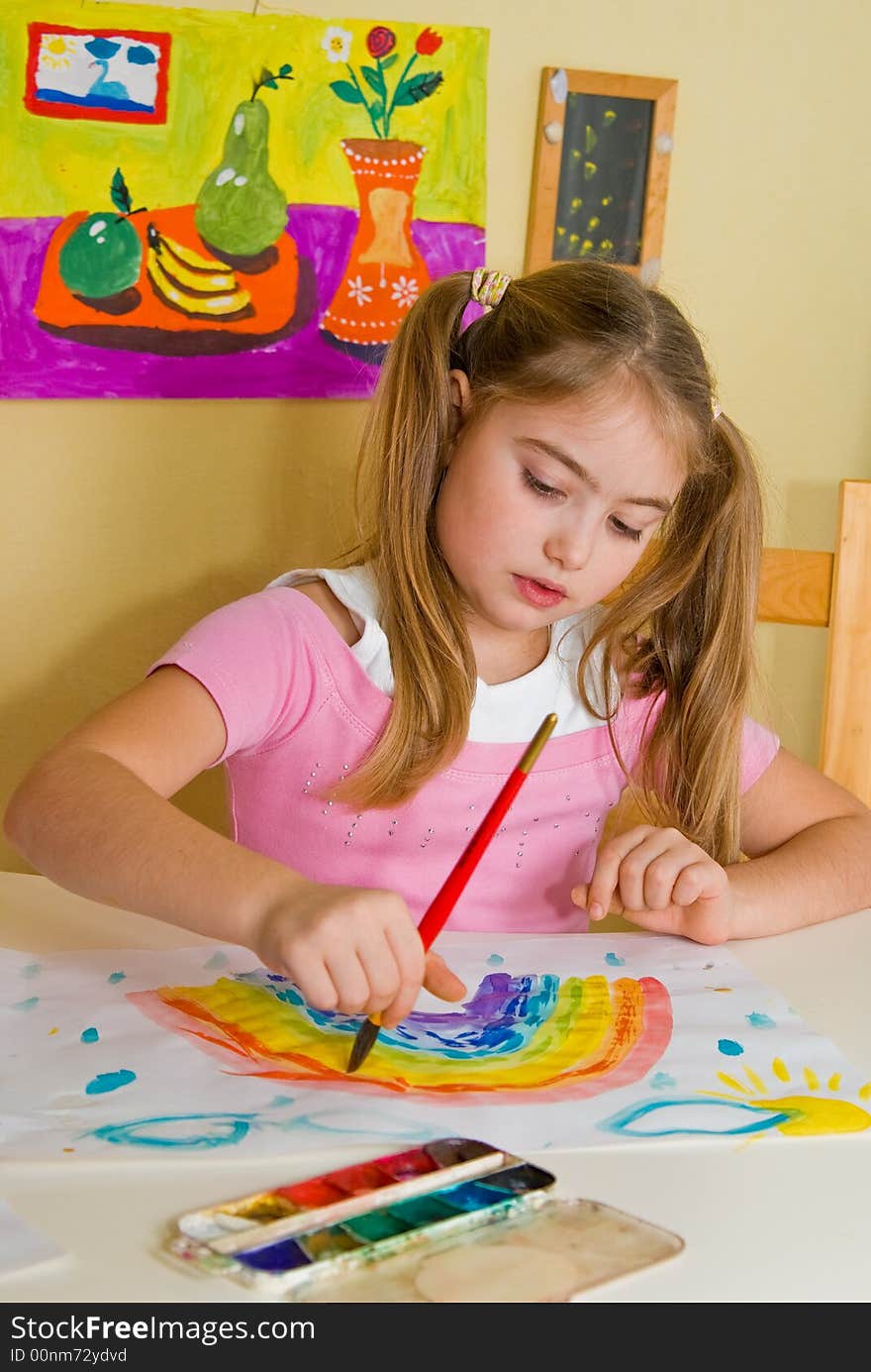 Pretty schoolgirl has drawn a rainbow