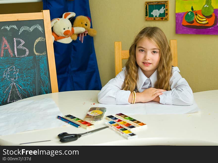 Schoolgirl sits at the table