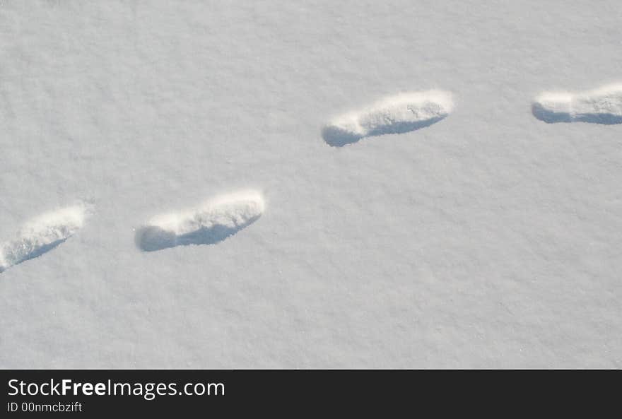 Man's traces  is photographed  on snow  background. Man's traces  is photographed  on snow  background