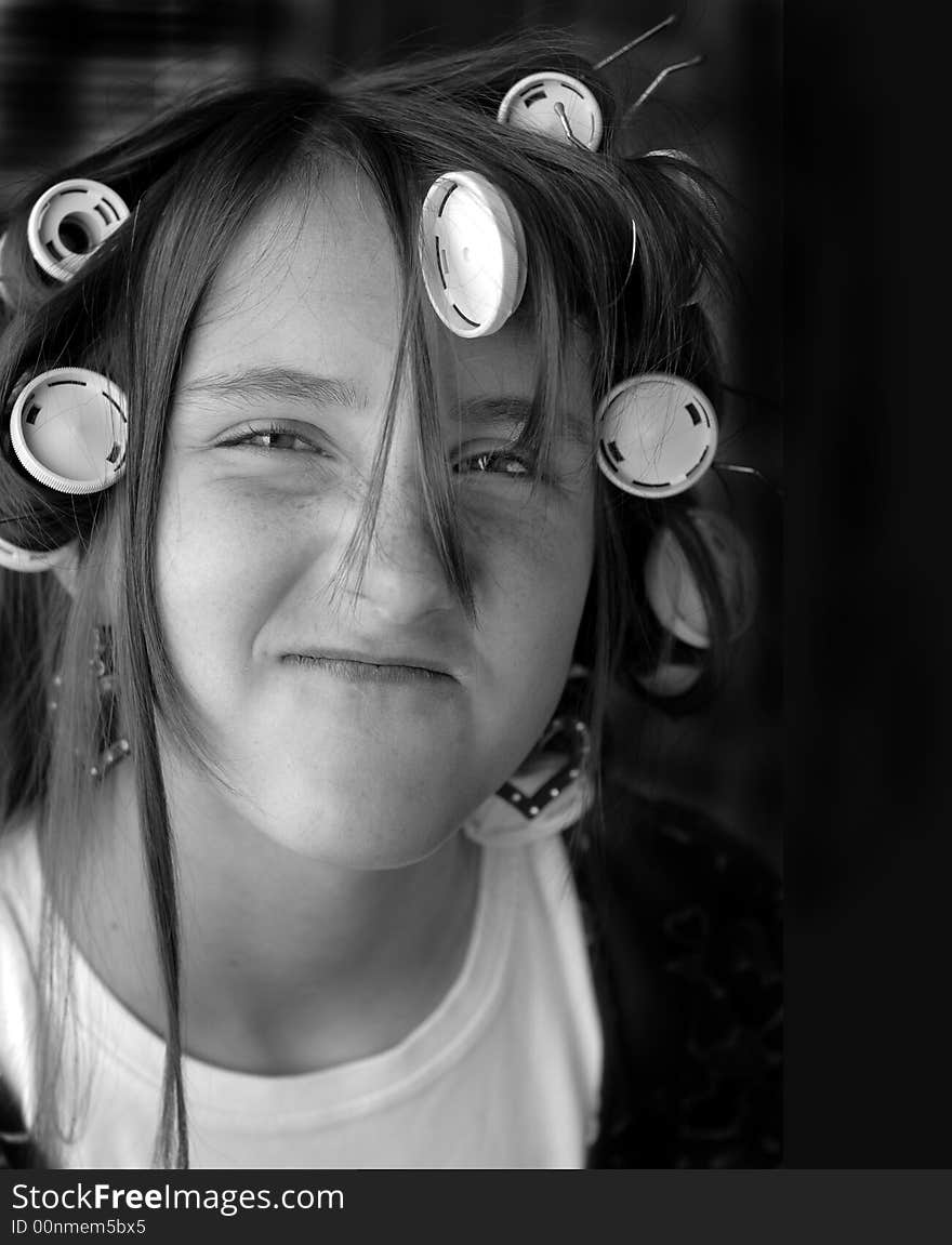 Portrait of teenage girl with curlers in her hair. Portrait of teenage girl with curlers in her hair