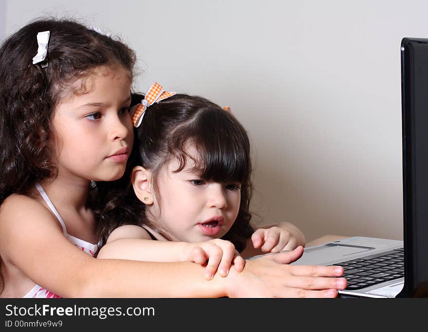 Two little girl work in the computer. Two little girl work in the computer