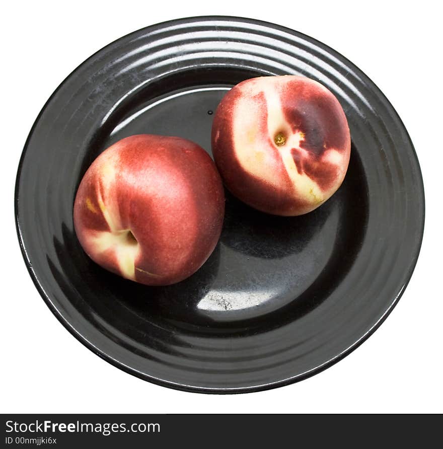 Close-up of fresh peaches on a black plate