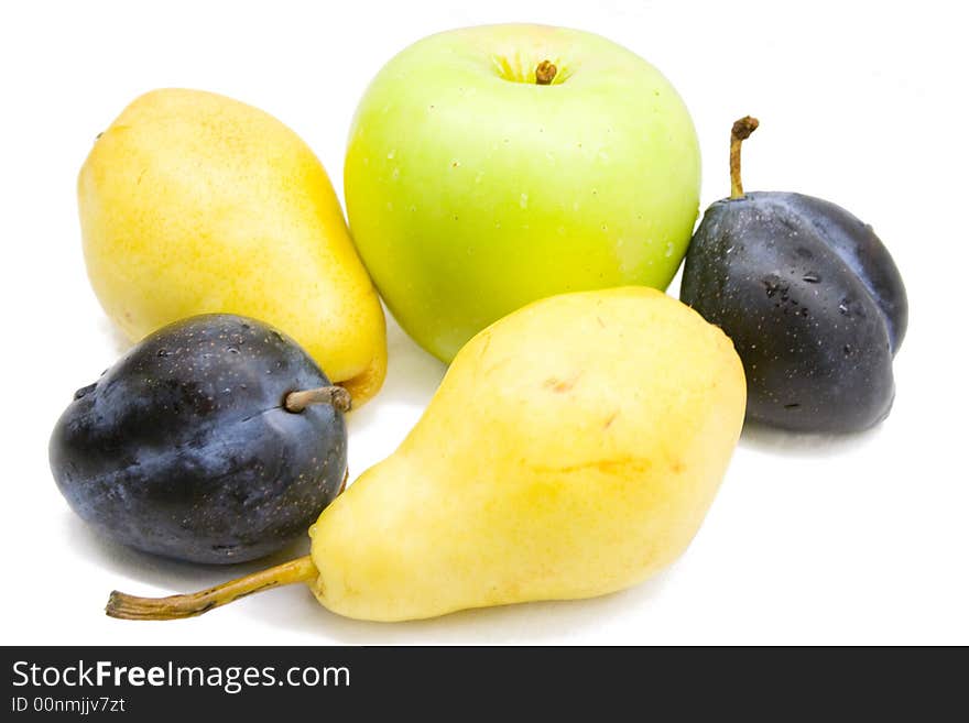 Close-up of fresh yellow pears, green apple and plums. Close-up of fresh yellow pears, green apple and plums