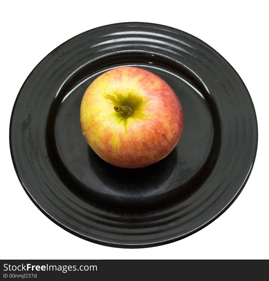 Close-up of fresh apple on a black plate