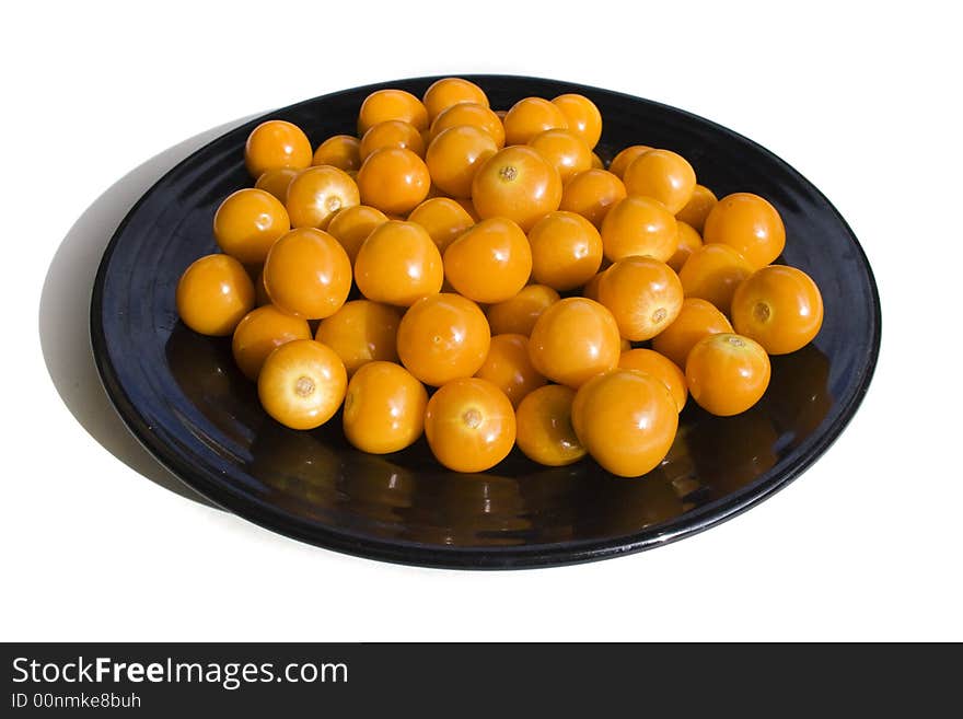 Close-up of black plate with cape gooseberries. Close-up of black plate with cape gooseberries