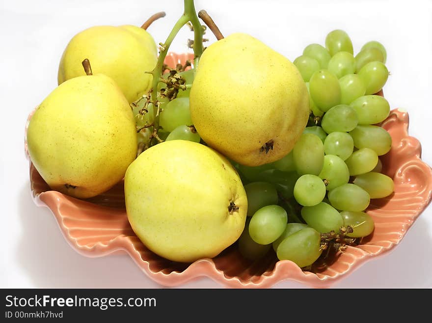 Pears and grapes in pink vase