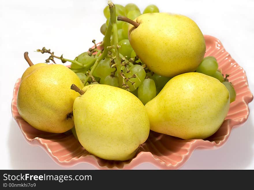 Pears and grapes in pink vase