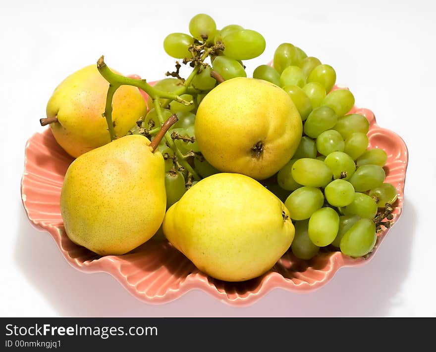 Pears and grapes in pink vase