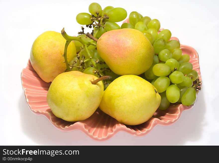 Pears and grapes in pink vase