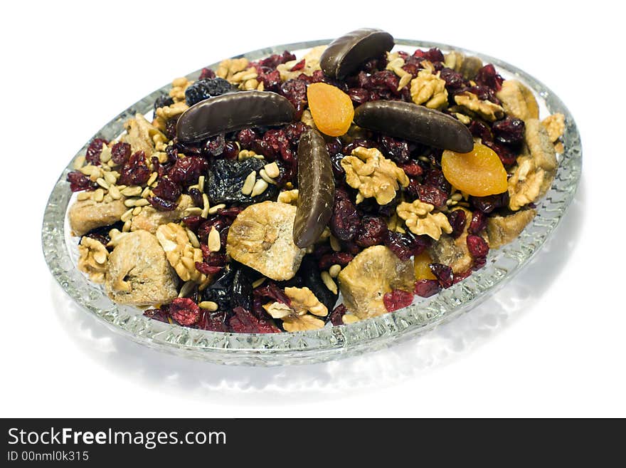 Crystal plate with sweetmeats and chocolate in white background