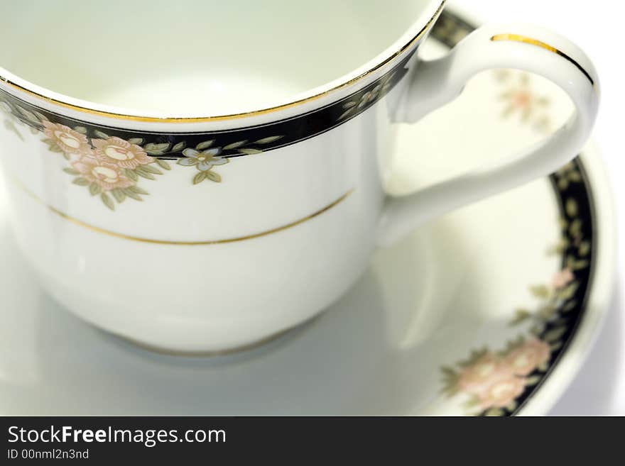 Macro close-up of porcelain tea cup and saucer with white background. Macro close-up of porcelain tea cup and saucer with white background