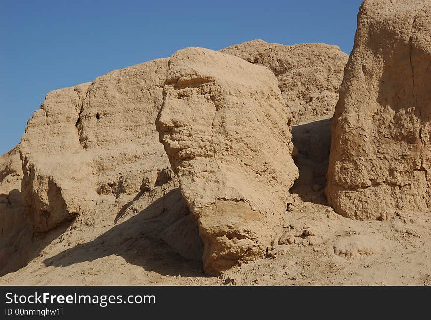 Photo at Khocho Ruins (Gaochang Gucheng), 
Turpan, Xinjiang, China 
October, 2007

The Khocho Ruins is located in the Mutougou river delta at the south foothill of the flame mountain and is 45 km from Turpan city of Xinjiang. It began construction in the B.C. first century of Han Dynasty. It is one of the treasured places of religion culture in the world. 
The Khocho Ruins assumes the rectangle shape with a perimeter of 5.4 km divided into three parts consisting of the outer city, the inner city and the imperial city. The outside wall base’s width is 12 meters and the wall’s height is 11.5 meters and it was built with earth. There are nine gates in the entire and the west side of the north city gate has the best preservation.
Khocho Ruins was abandoned in the end of the 13 century’s because of wars and majority of the buildings vanished. At present, the southwest and southeast corner outer city gate preserves two temples ruins. There is an irregular shape small castle in the center of the north inner city and the native calls it the khan fort. In 1961, Khocho Ruins is listed as one of the country’s key cultural relic preservation organ. Photo at Khocho Ruins (Gaochang Gucheng), 
Turpan, Xinjiang, China 
October, 2007

The Khocho Ruins is located in the Mutougou river delta at the south foothill of the flame mountain and is 45 km from Turpan city of Xinjiang. It began construction in the B.C. first century of Han Dynasty. It is one of the treasured places of religion culture in the world. 
The Khocho Ruins assumes the rectangle shape with a perimeter of 5.4 km divided into three parts consisting of the outer city, the inner city and the imperial city. The outside wall base’s width is 12 meters and the wall’s height is 11.5 meters and it was built with earth. There are nine gates in the entire and the west side of the north city gate has the best preservation.
Khocho Ruins was abandoned in the end of the 13 century’s because of wars and majority of the buildings vanished. At present, the southwest and southeast corner outer city gate preserves two temples ruins. There is an irregular shape small castle in the center of the north inner city and the native calls it the khan fort. In 1961, Khocho Ruins is listed as one of the country’s key cultural relic preservation organ.