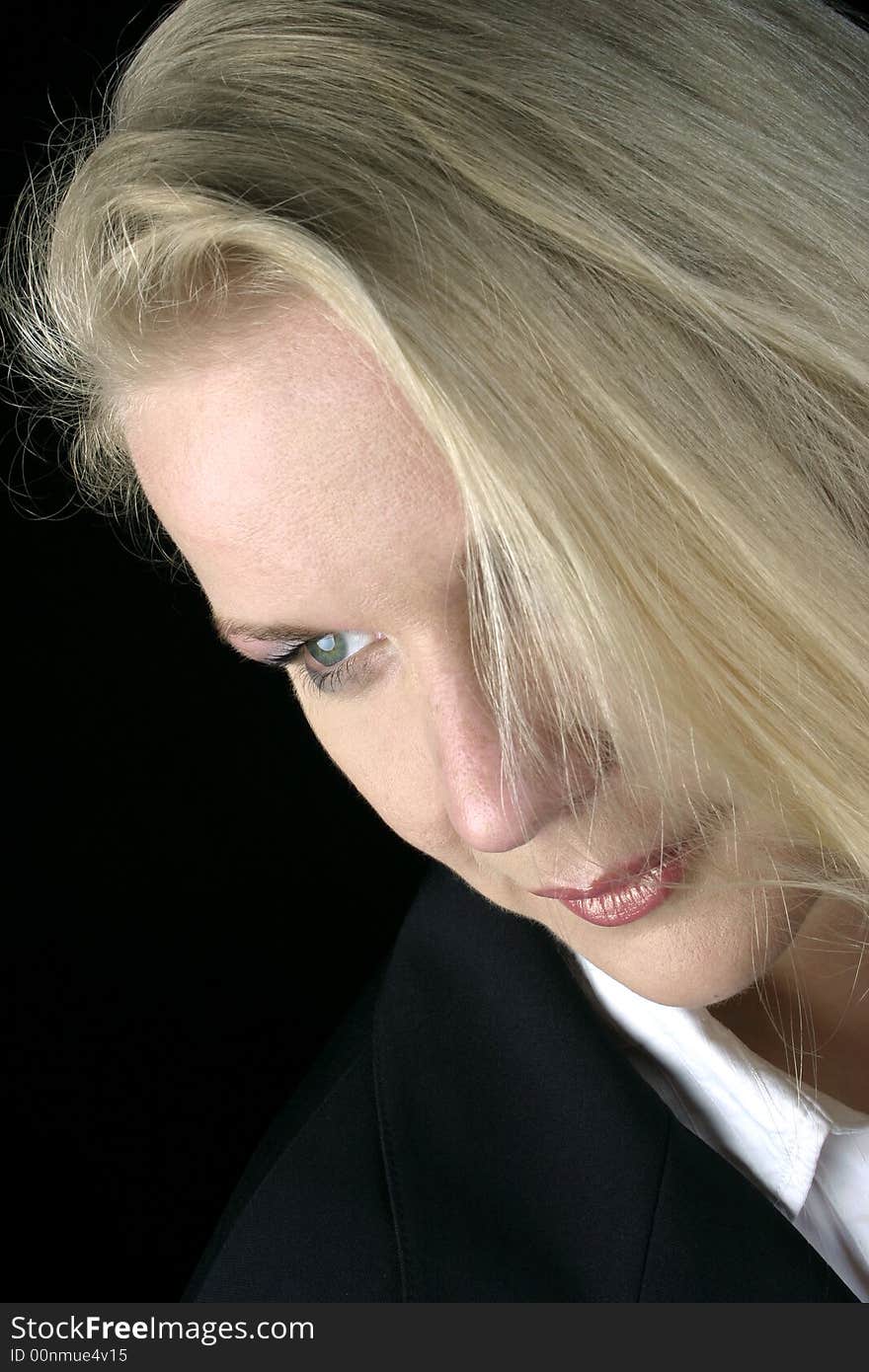 Portrait of a blond woman, black background