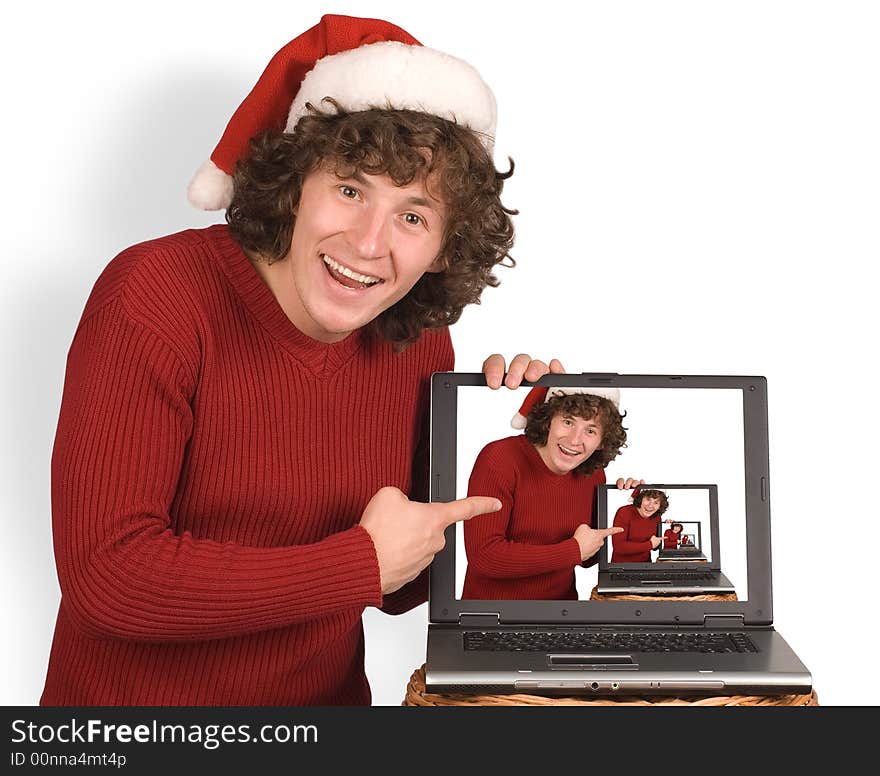 Young the man in cap Santa Claus with a computer on a white background. Young the man in cap Santa Claus with a computer on a white background