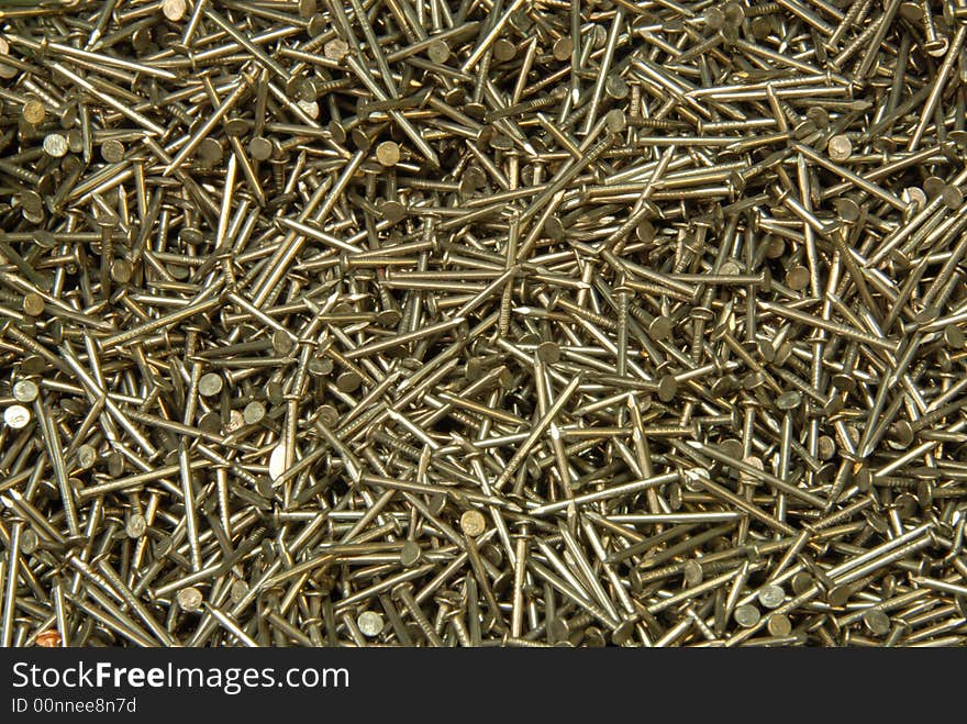 The heap of nails lays on a surface