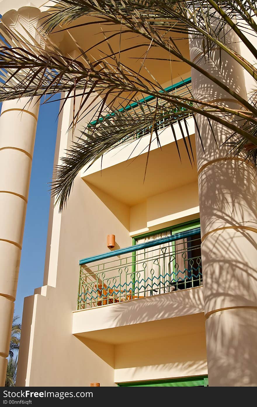 Hotel's balcony with palm leaves