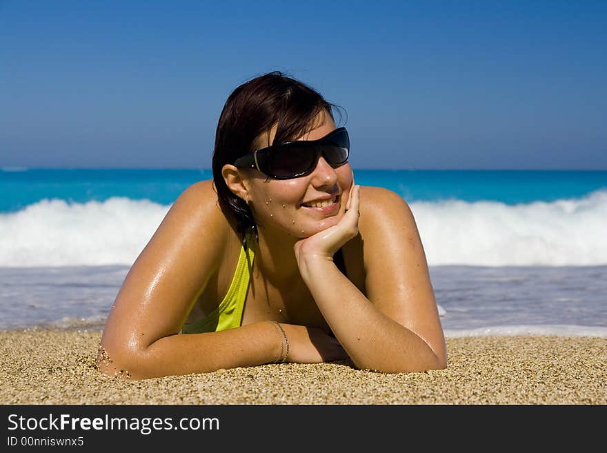 Young woman is relaxing on the beautiful beach. Young woman is relaxing on the beautiful beach.