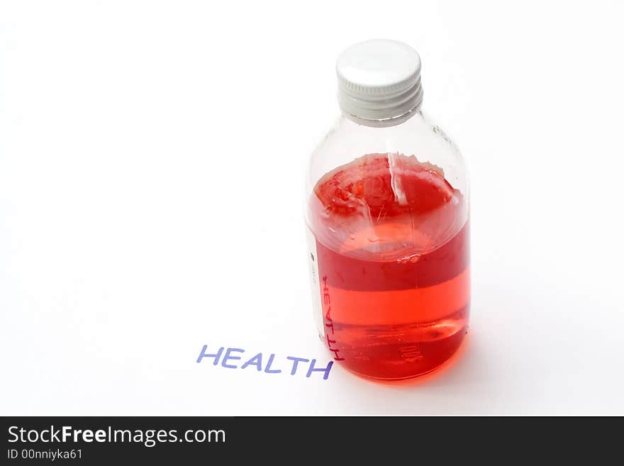 A bottle of red syrup medicine next to the word health. A bottle of red syrup medicine next to the word health