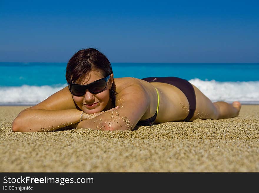 Young woman is relaxing on the beautiful beach. Young woman is relaxing on the beautiful beach.