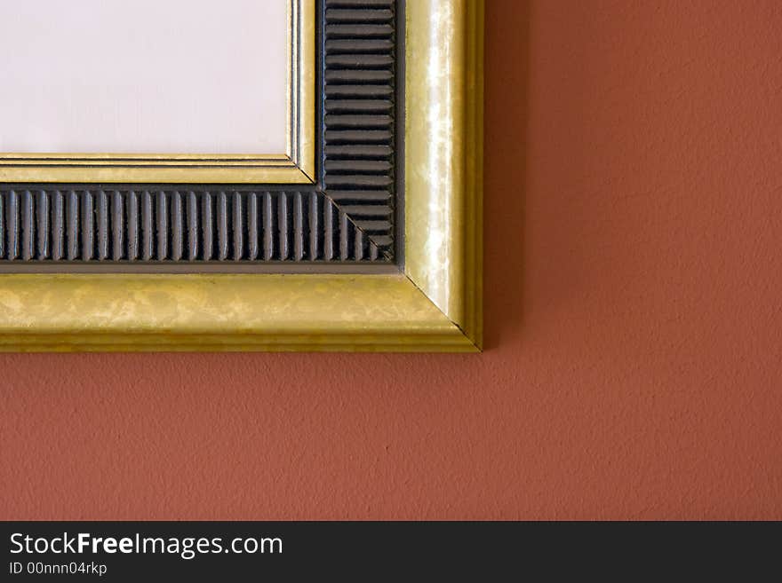 Gilt edged frame on a terra cotta wall