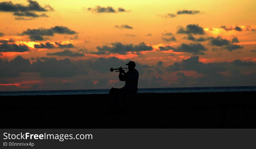 Silhouette of a lonely trumpeter at sunset. Silhouette of a lonely trumpeter at sunset