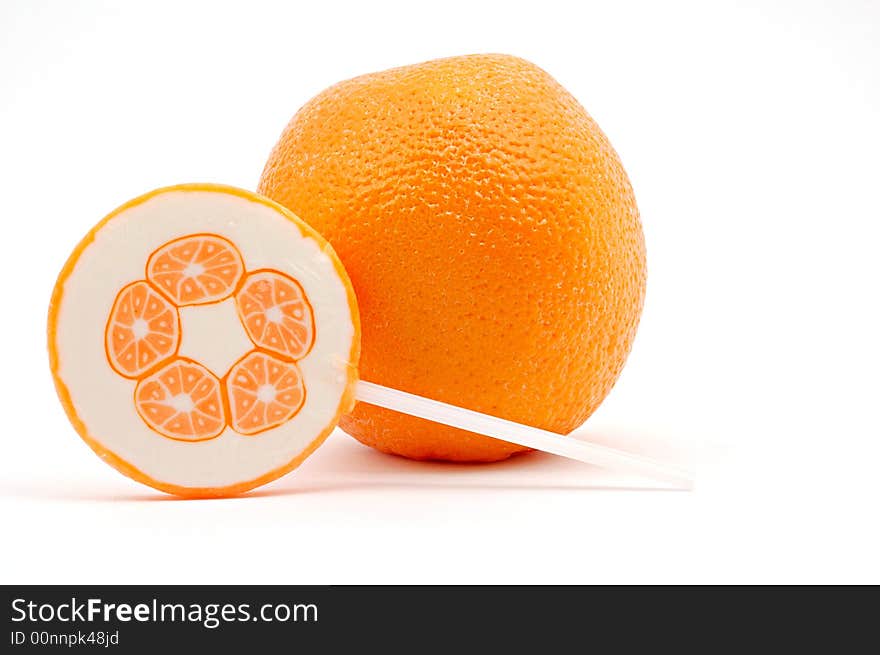 Orange with a lollipop on white background. Orange with a lollipop on white background