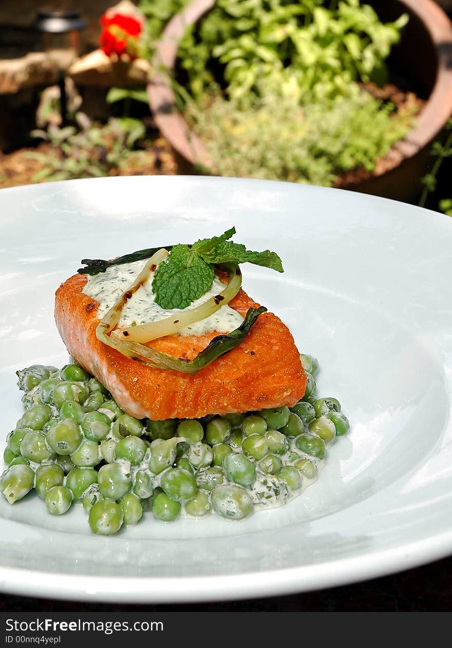 Baked salmon over fresh peas