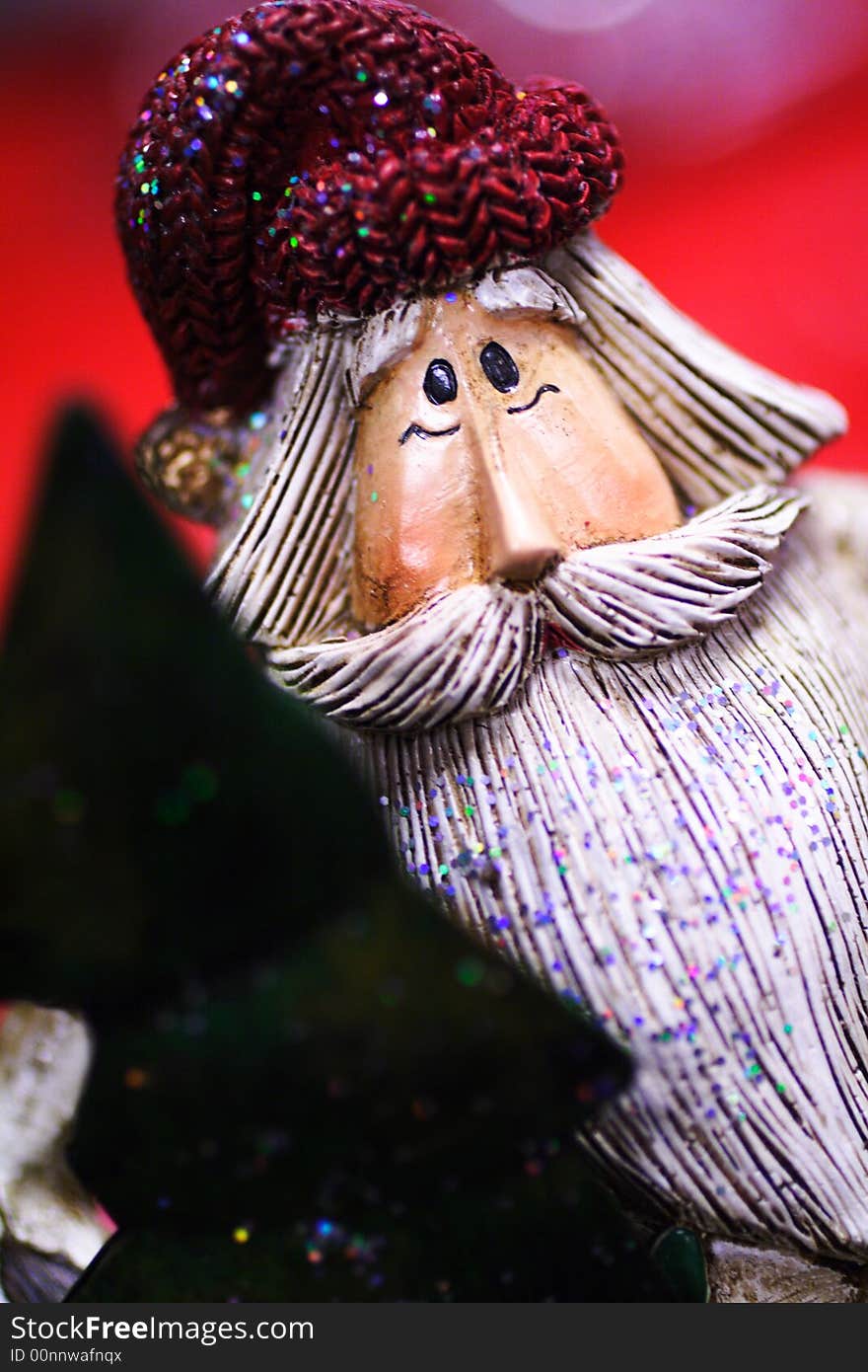 Wooden santa clause with cap and tree