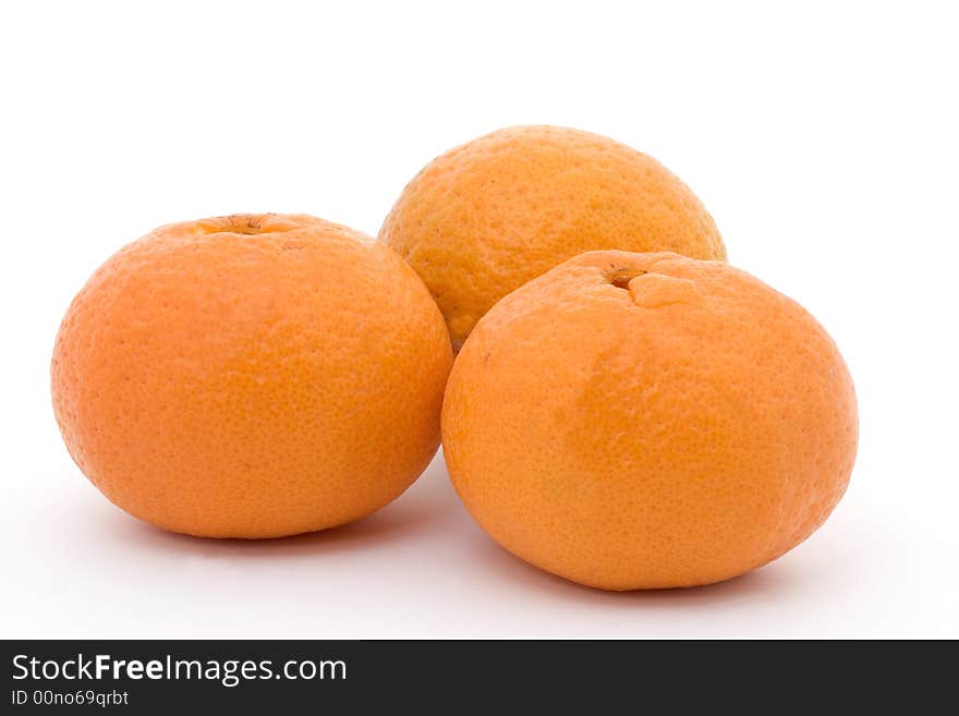 Three orange tangerines on a white background. Three orange tangerines on a white background