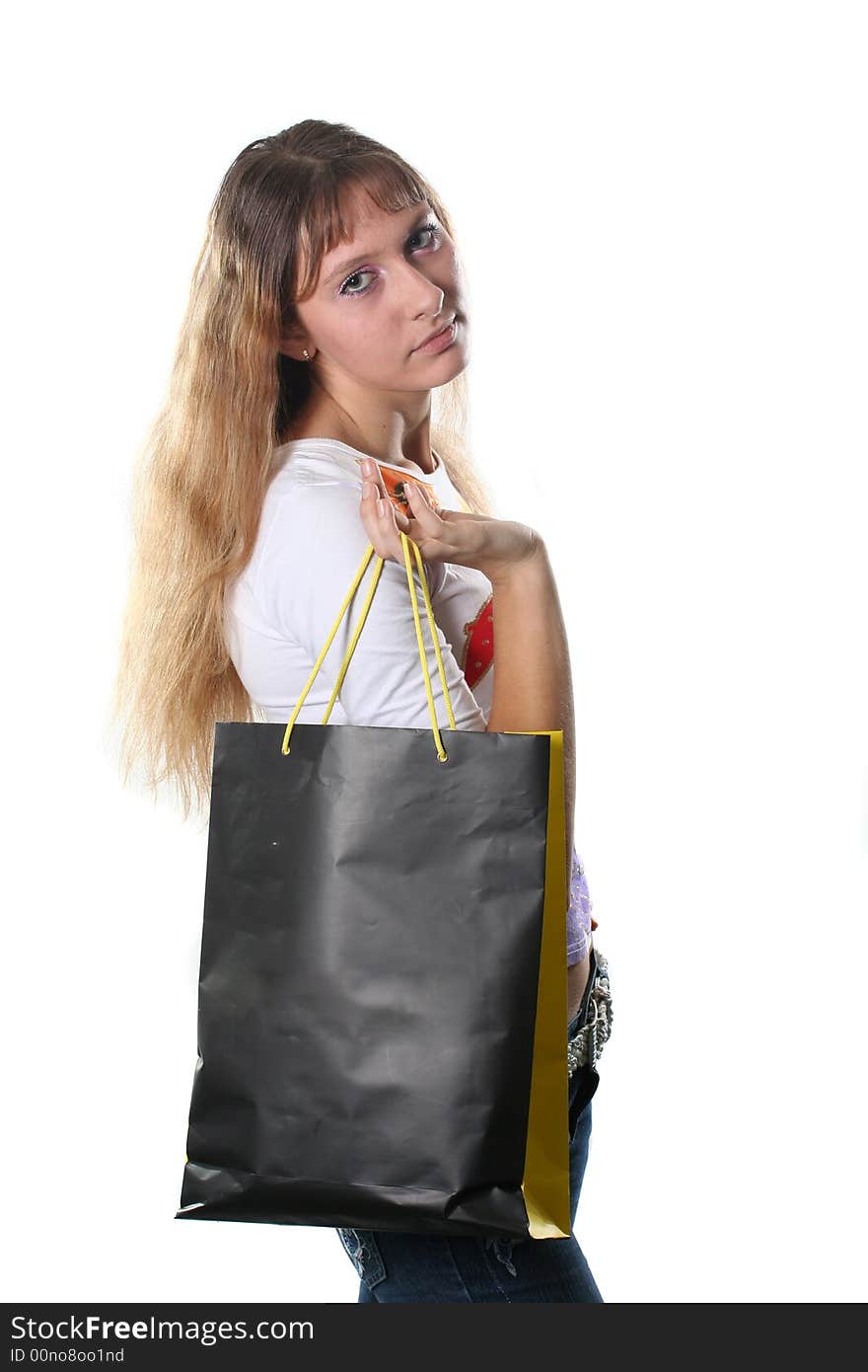 The beautiful high girl with a bag for purchases poses on a white background. The beautiful high girl with a bag for purchases poses on a white background