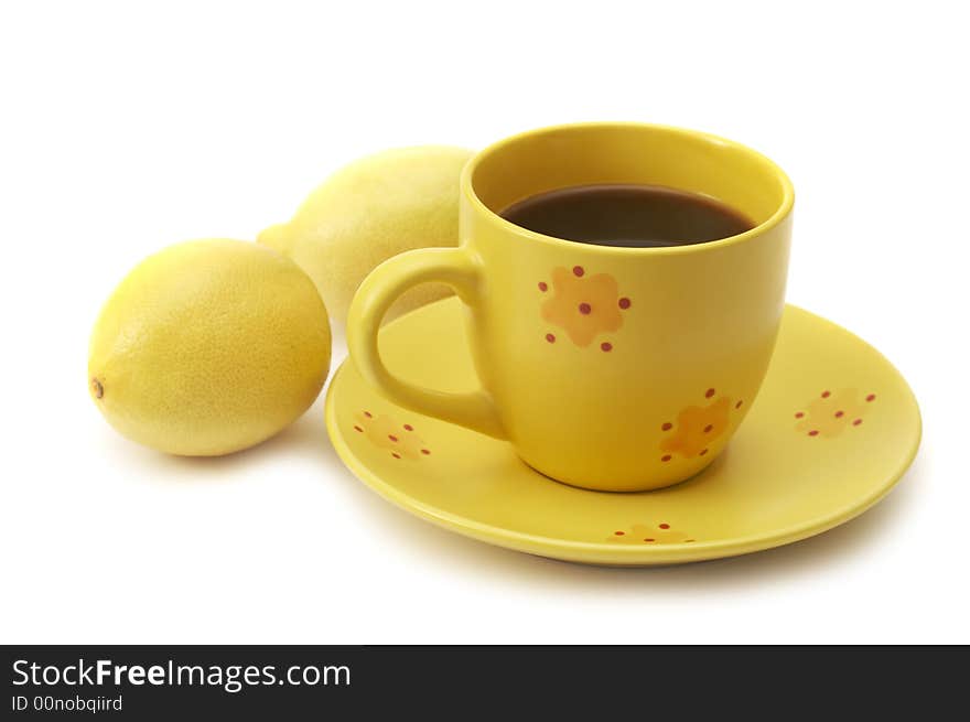 Yellow coffee cup and lemons isolated over white background