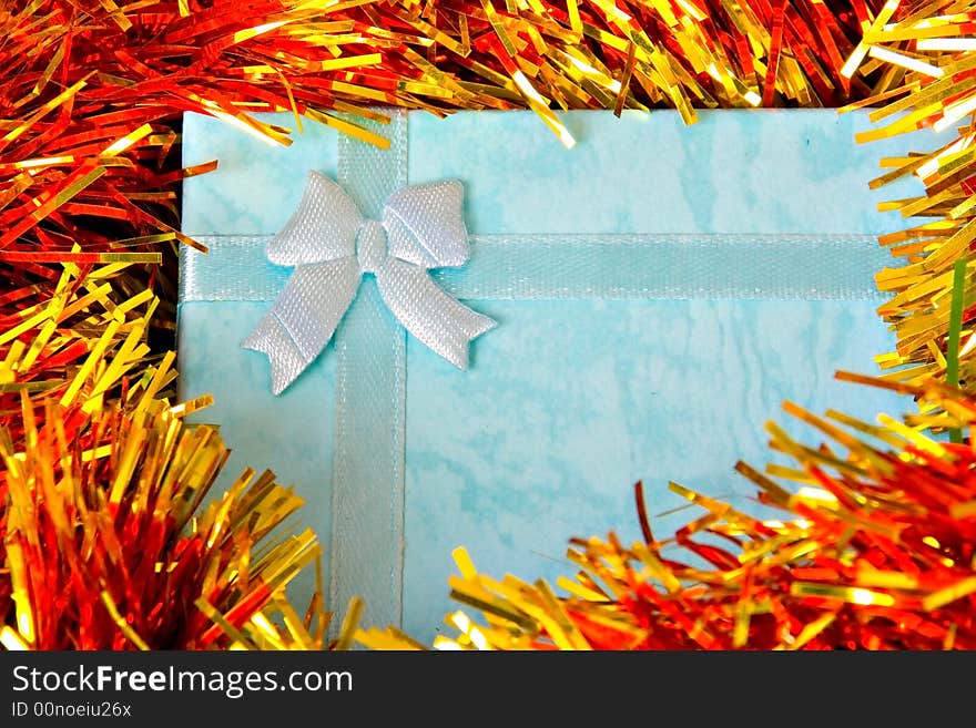 Blue Christmas gift with ribbon on colorful  decorations. Blue Christmas gift with ribbon on colorful  decorations