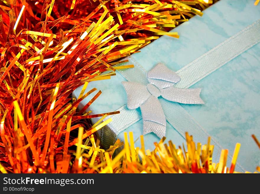 Blue Christmas gift with ribbon on colorful  decorations