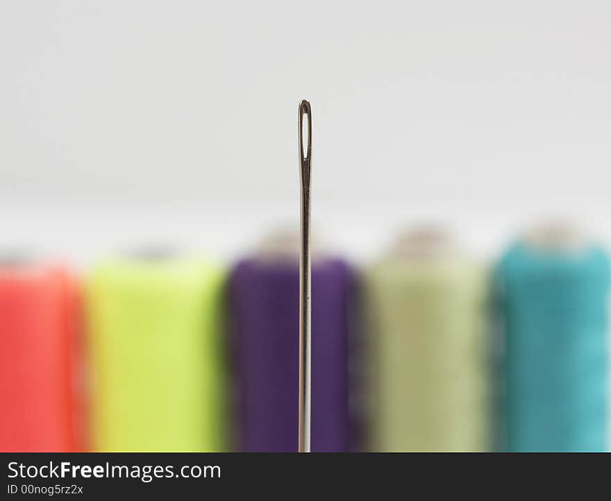 Colorful bobbins and needle