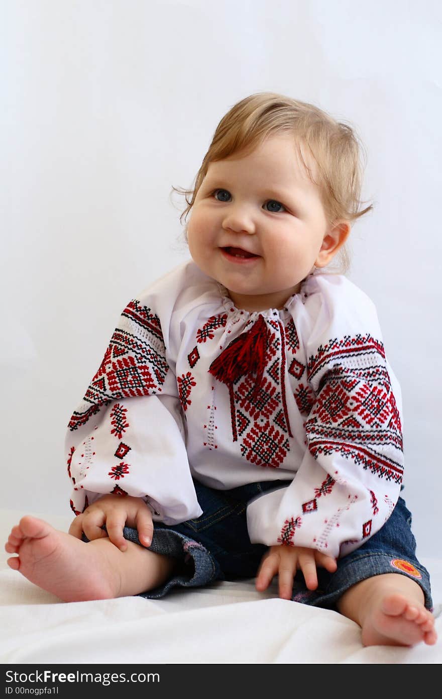 Little girl in the embroidered shirt and jeans