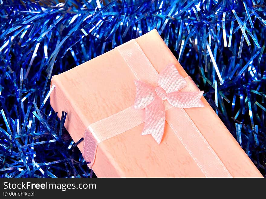 Pink Christmas gift with ribbon on gold  decorations. Pink Christmas gift with ribbon on gold  decorations