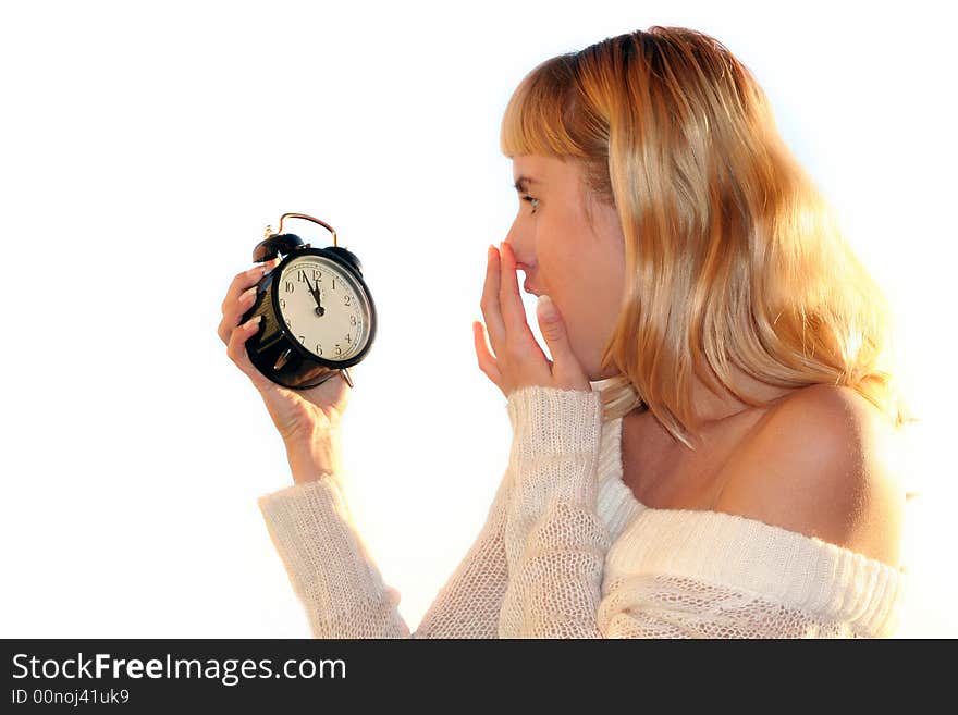 Young blond woman show time on alarm clock. The shot like concept of eve xmas or end of sales. Young blond woman show time on alarm clock. The shot like concept of eve xmas or end of sales