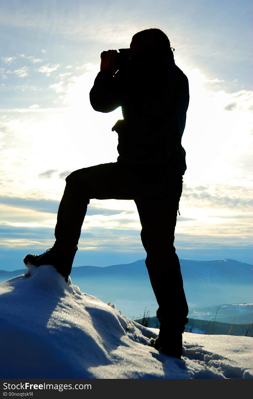 Silhouette of photographer on opposite of mountains. Silhouette of photographer on opposite of mountains